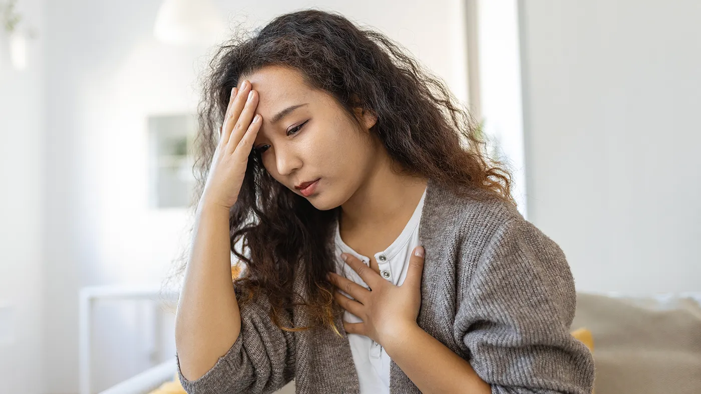 Woman experiencing neurological symptoms such as headache and dizziness related to epilepsy clinical trials available nationwide through Equity Medical