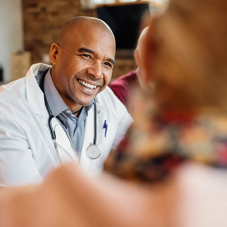 Friendly doctor consulting with patient about psoriatic arthritis clinical trials at Equity Medical nationwide