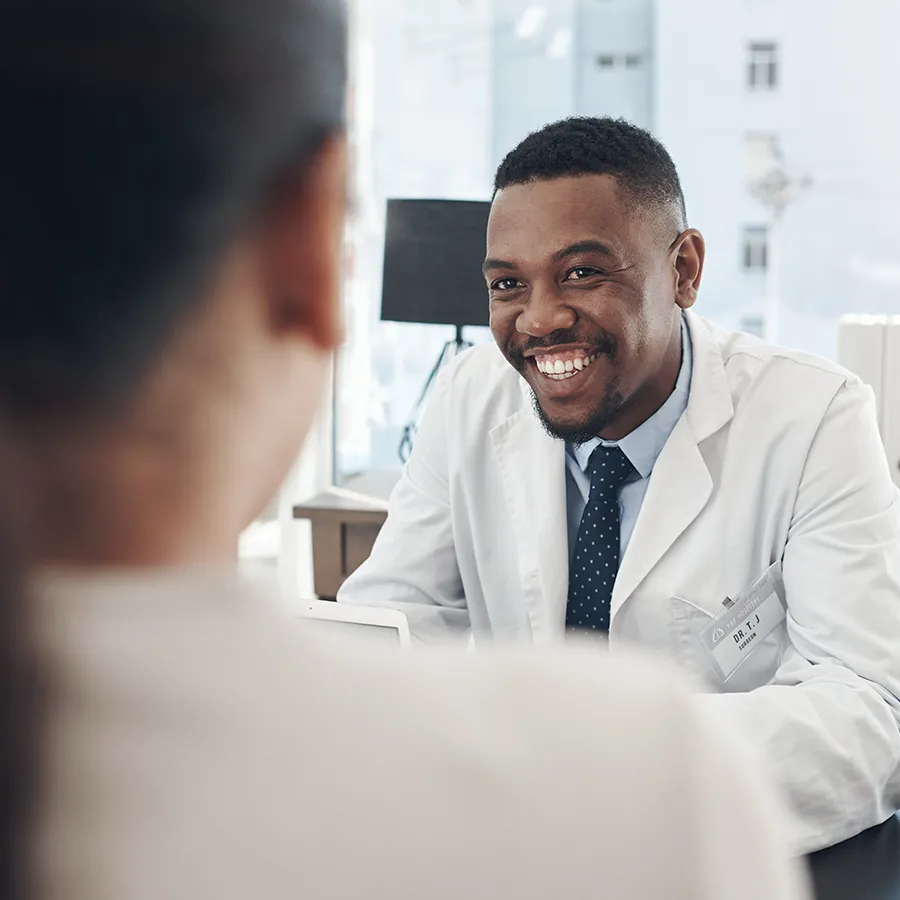 Doctor smiling and speaking with patient about multiple sclerosis clinical trials available across the US through Equity Medical