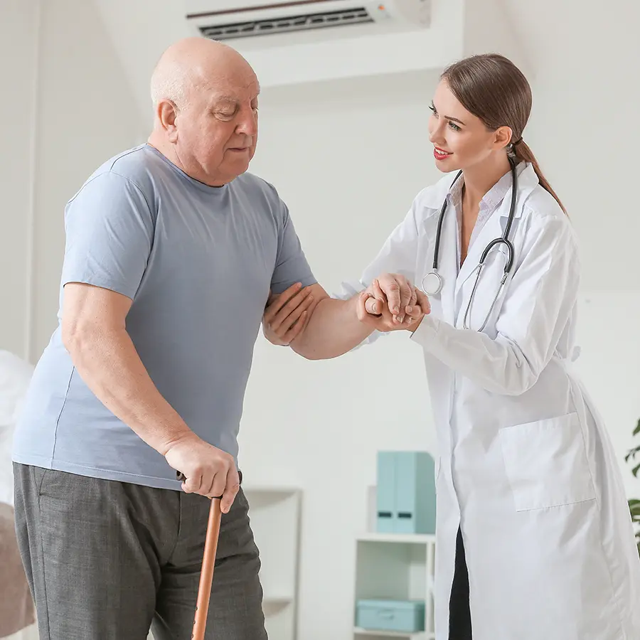 Doctor assisting elderly patient with walking and mobility challenges, representing Parkinson's clinical trials with nationwide access through Equity Medical