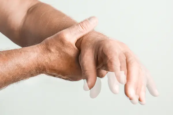 Older adult experiencing movement disorder symptoms while holding a glass during Equity Medical nationwide clinical trials research