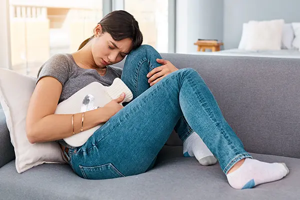 Woman experiencing pelvic discomfort associated with PCOS during Equity Medical nationwide clinical trials research.