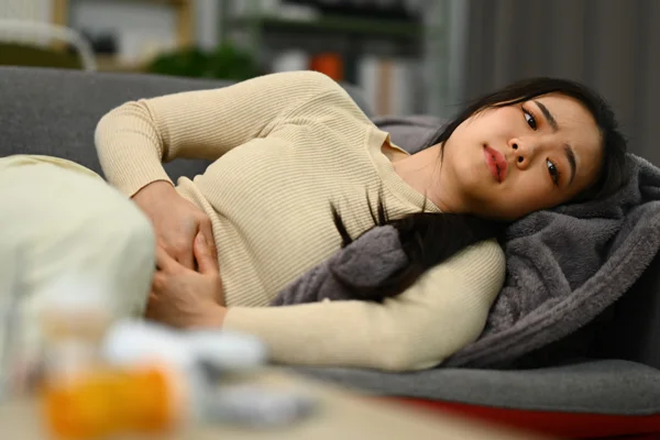 Woman experiencing pelvic pain related to endometriosis clinical trials at Equity Medical.