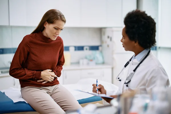 Patient discussing pelvic pain and uterine fibroids clinical trials with a provider at Equity Medical.