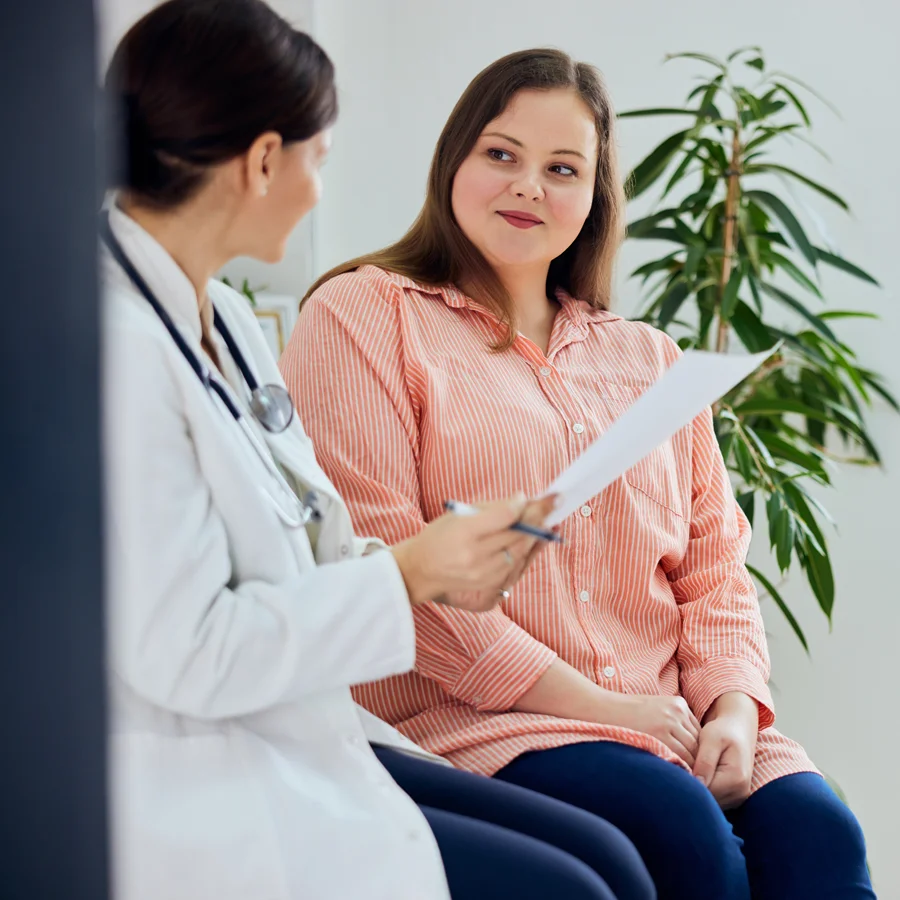 Participant reviewing vaginal yeast infection clinical trial information with an Equity Medical research physician.
