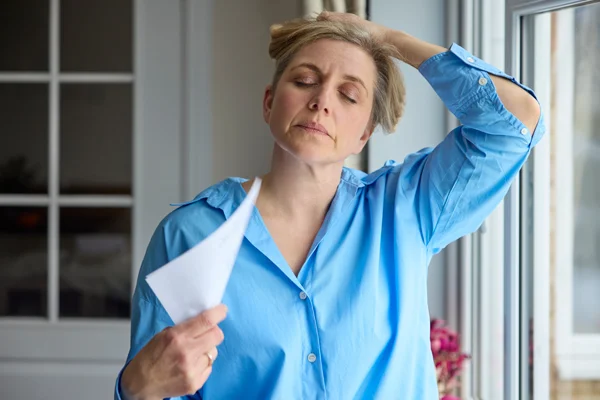 Woman experiencing menopause symptoms, an area of women’s health clinical trials at Equity Medical in Owensboro, KY.